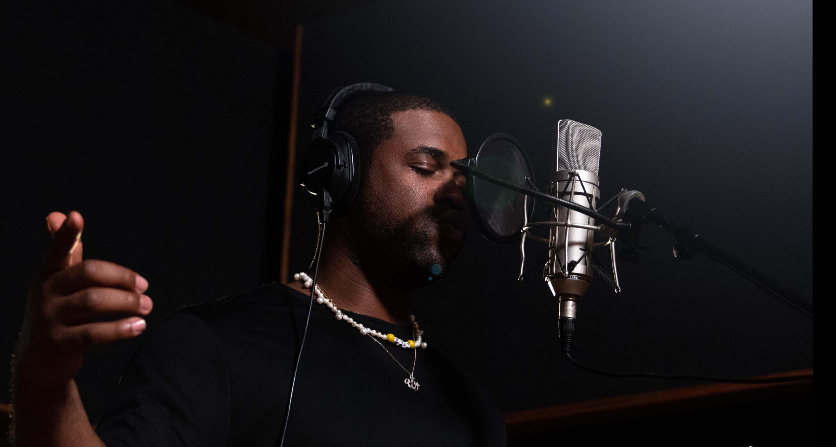 A$AP Ferg laying down a track in front of the studio microphone, with a glass of Hennessy V.S cognac, neat.
