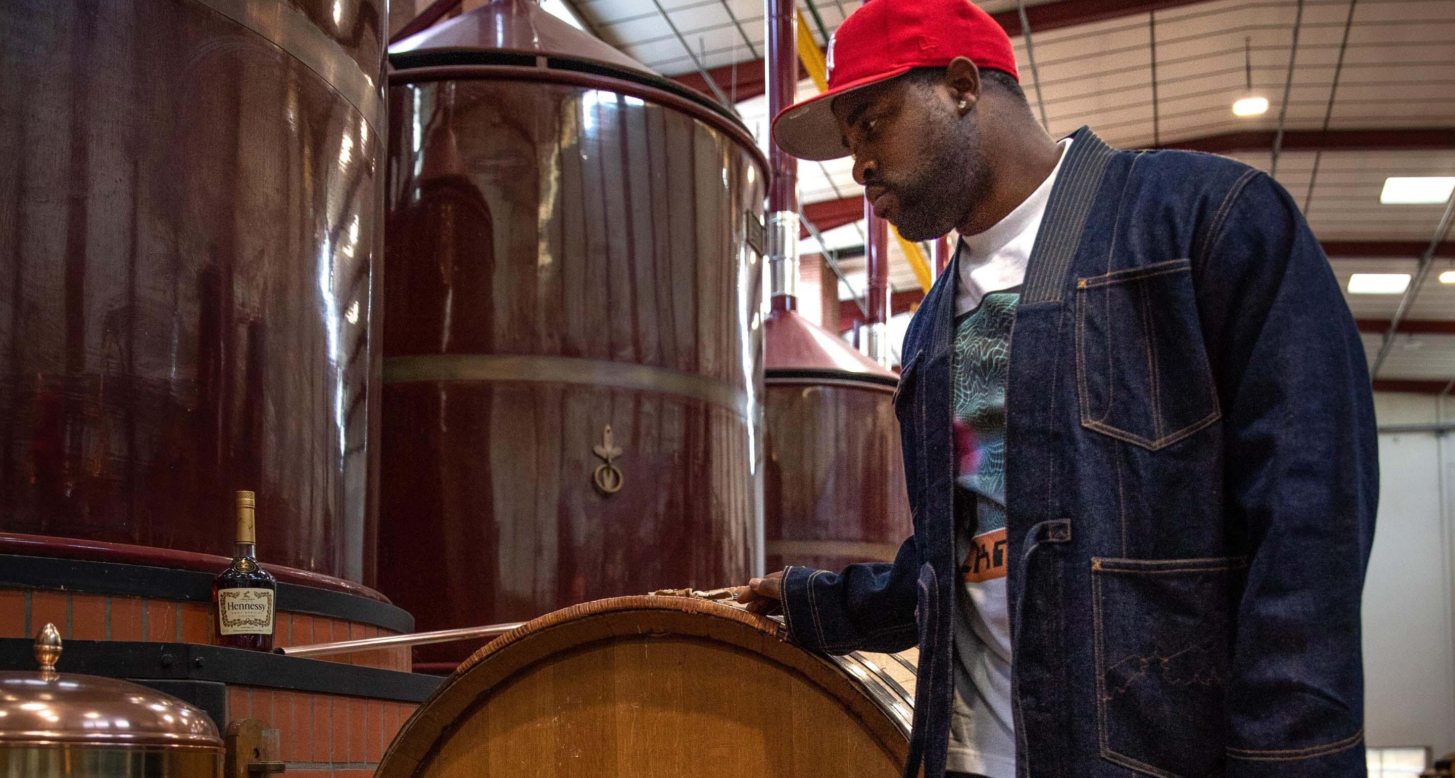 A$AP Ferg looking at the equipment in the Hennessy distillery.