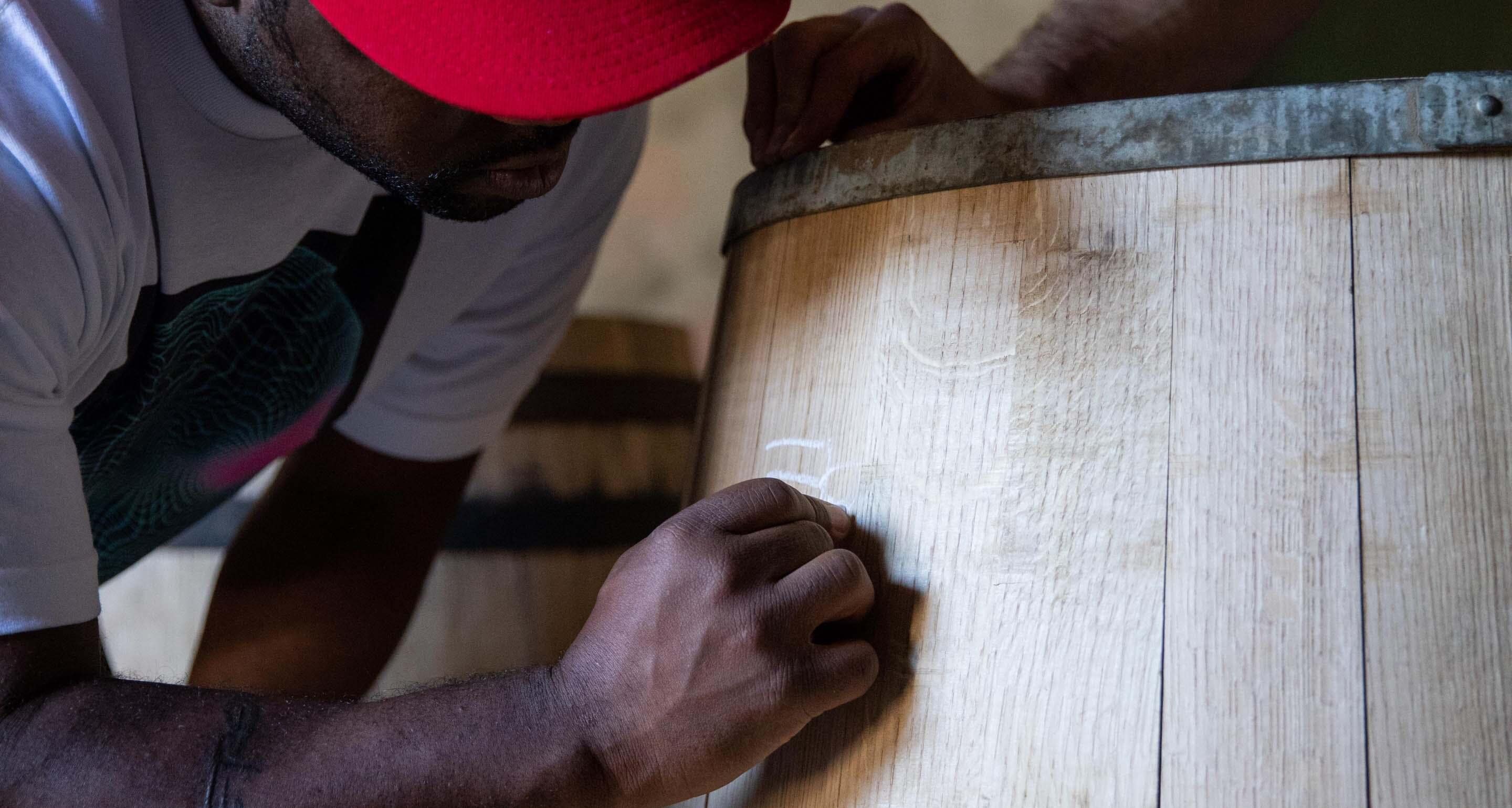 ASAP Ferg signing a Hennessy barrel he made with the Hennessy Master Cooper.