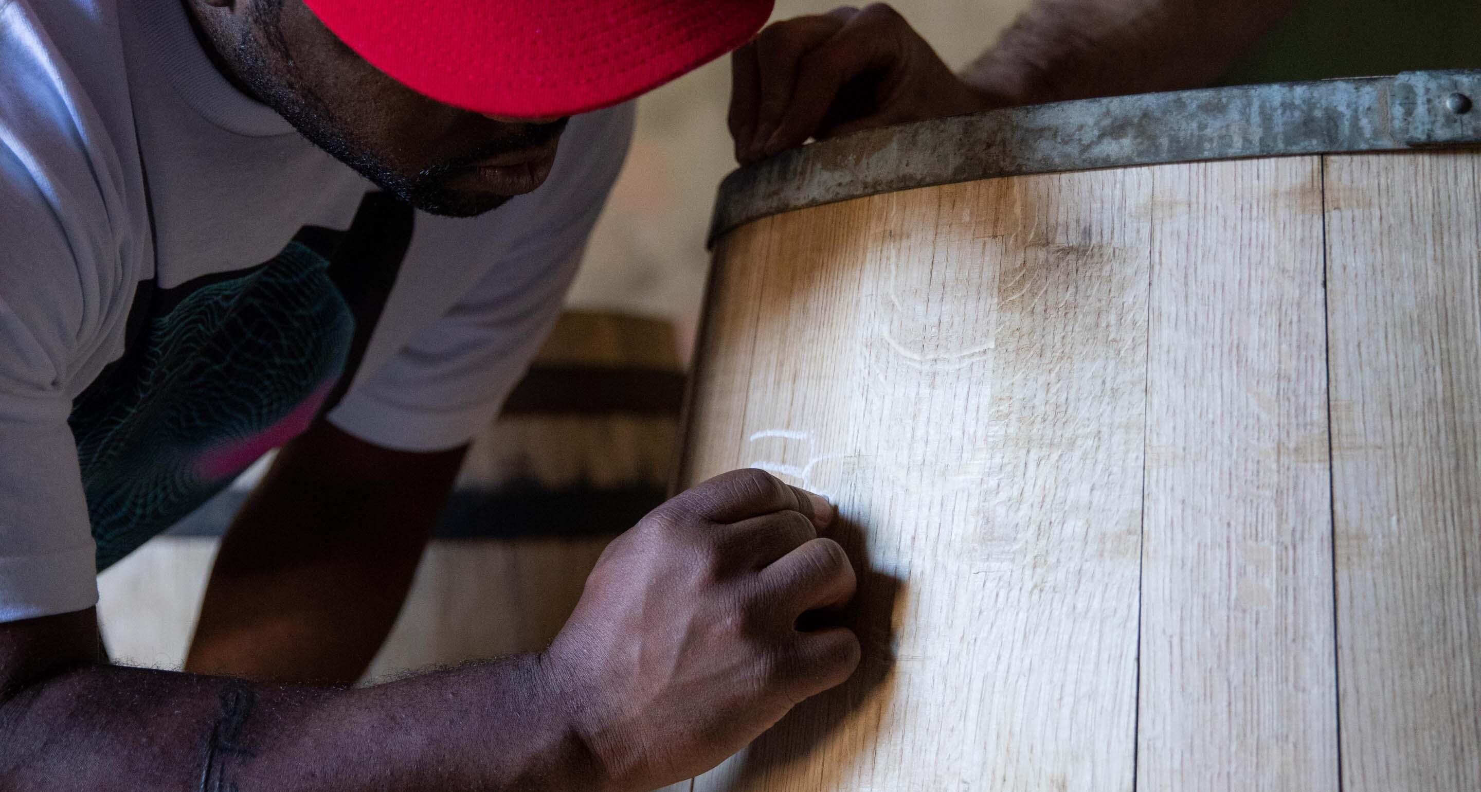 ASAP Ferg signing a Hennessy barrel he made with the Hennessy Master Cooper.