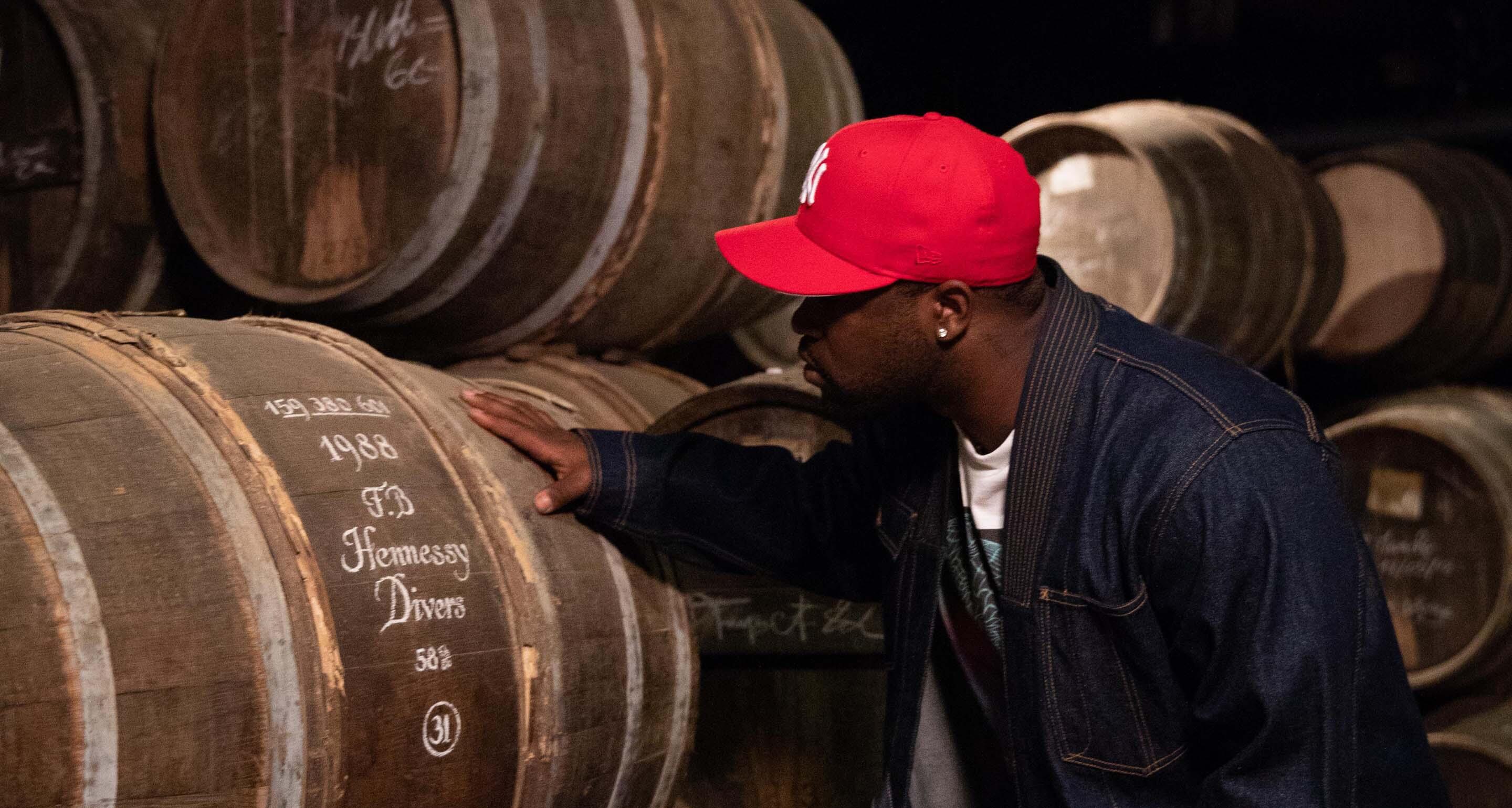 ASAP Ferg touching a cask that shares his birth year in the Hennessy cognac vault.