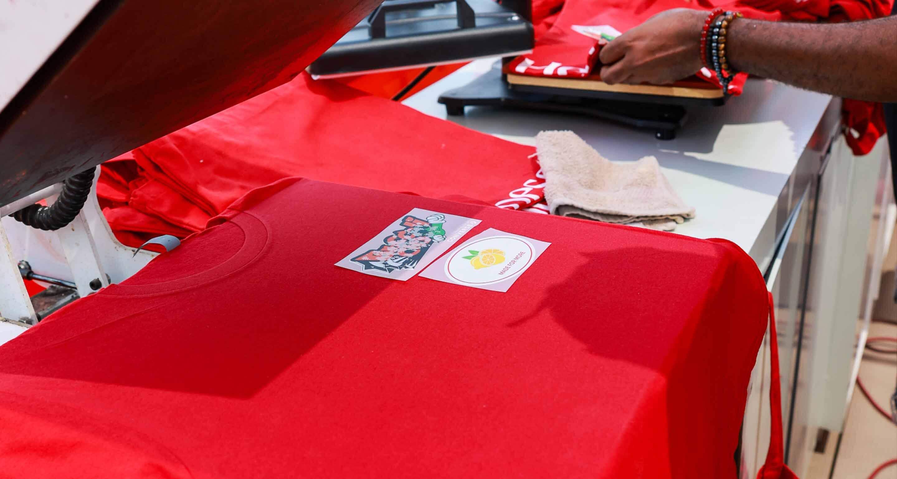 Vibrant Hennessy t-shirts on display, ready for customers to pick up.