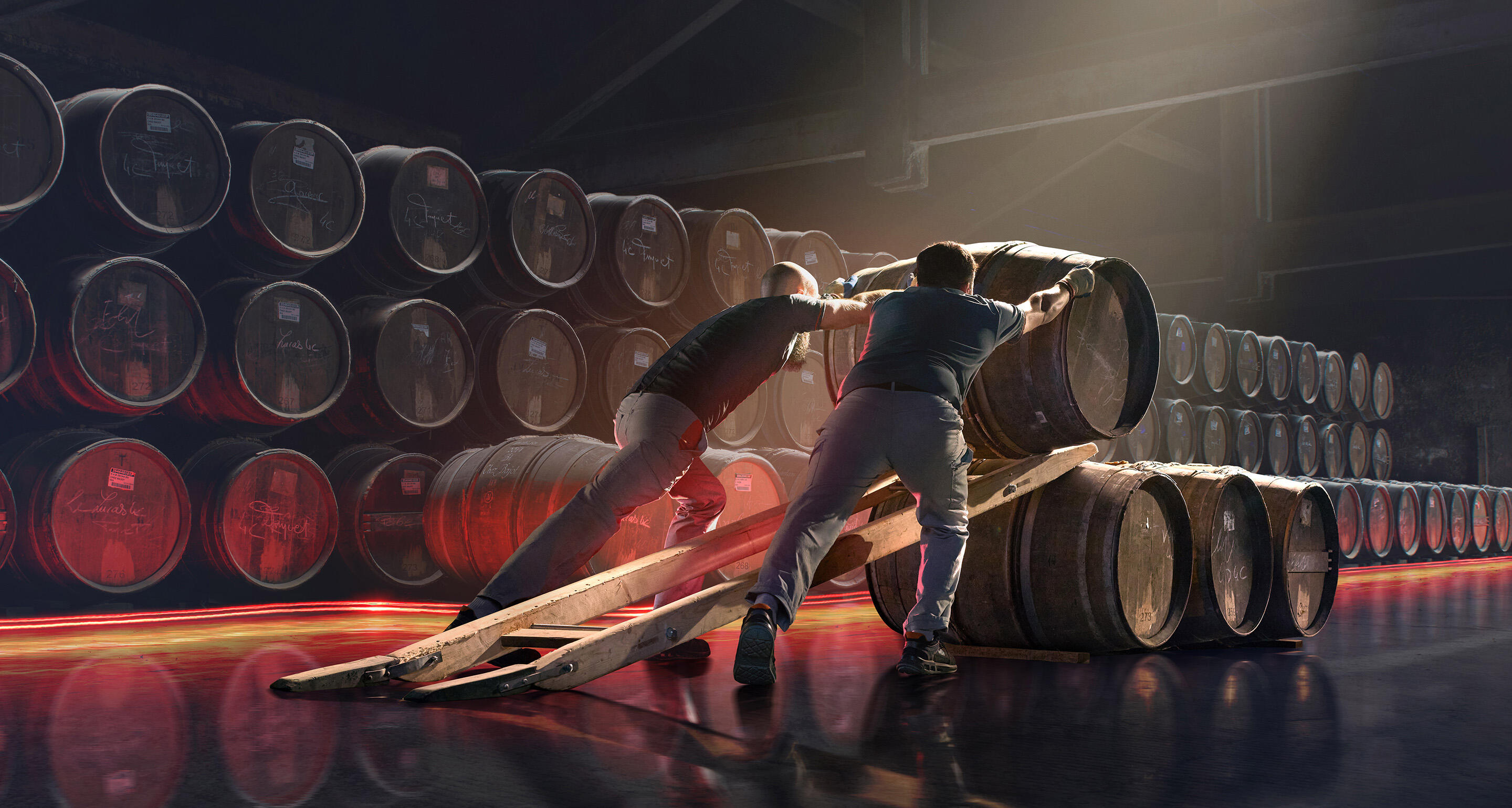 Hennessy cellar agents putting hundreds of oak barrels into place in a traditional ageing cellar