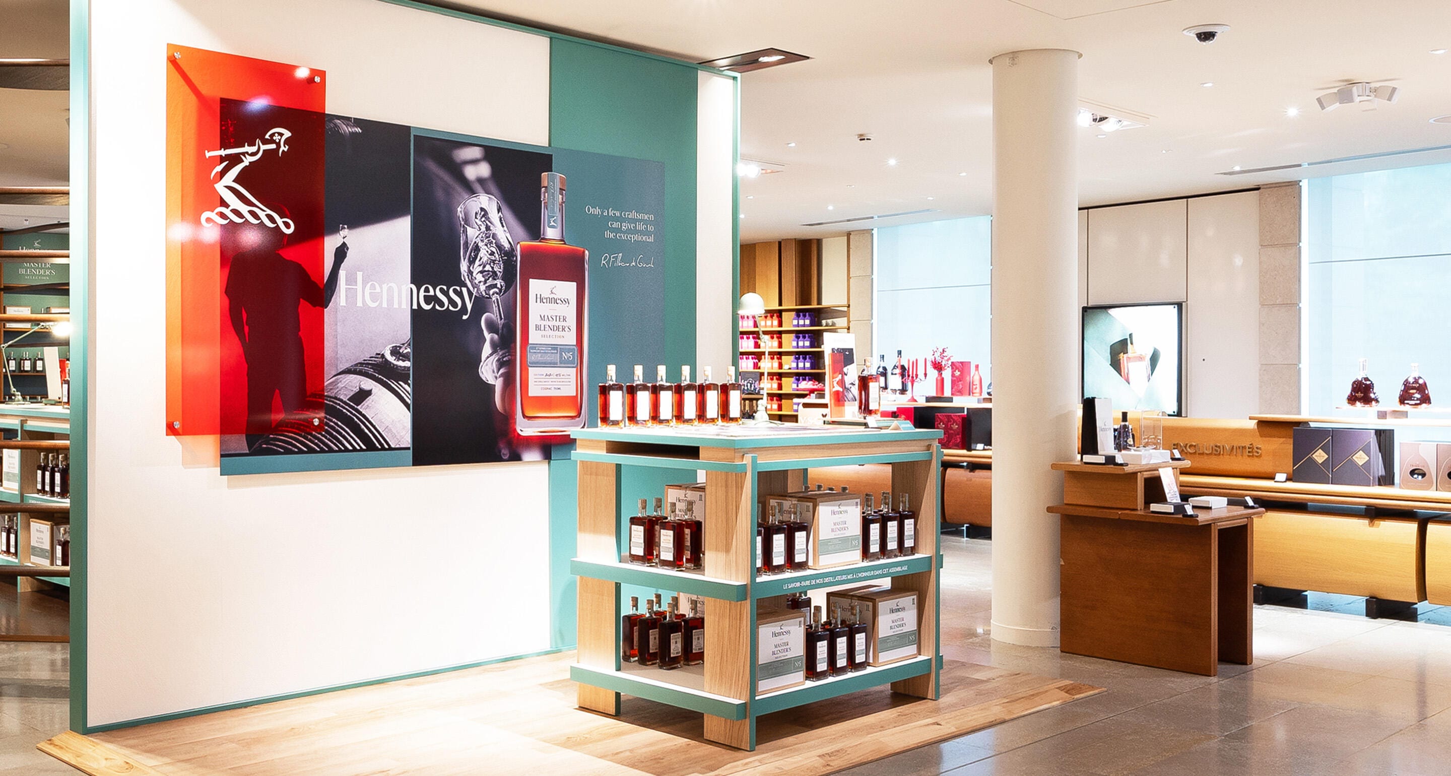 Close-up of colourful shelves displaying Hennessy bottles in the Cognac Boutique