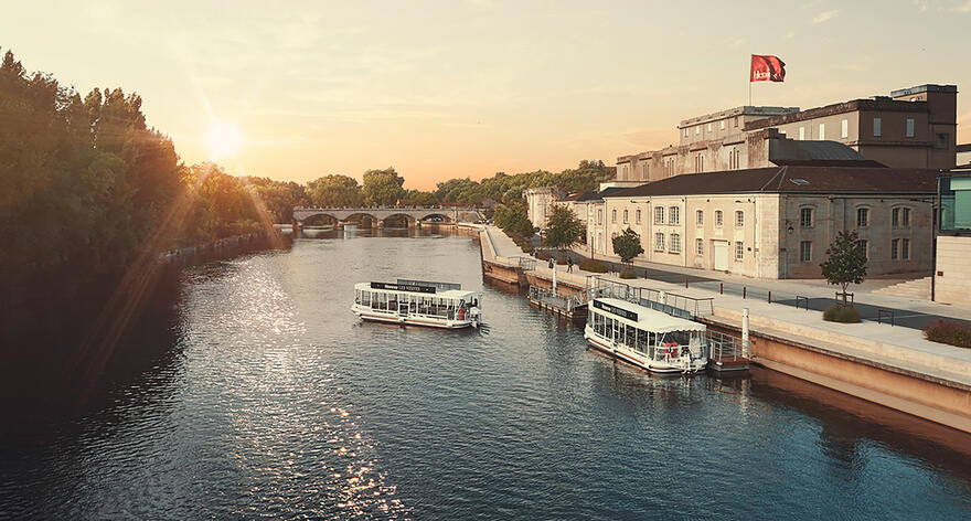 View of the Charente River with the two solar-powered boats from Hennessy Visites