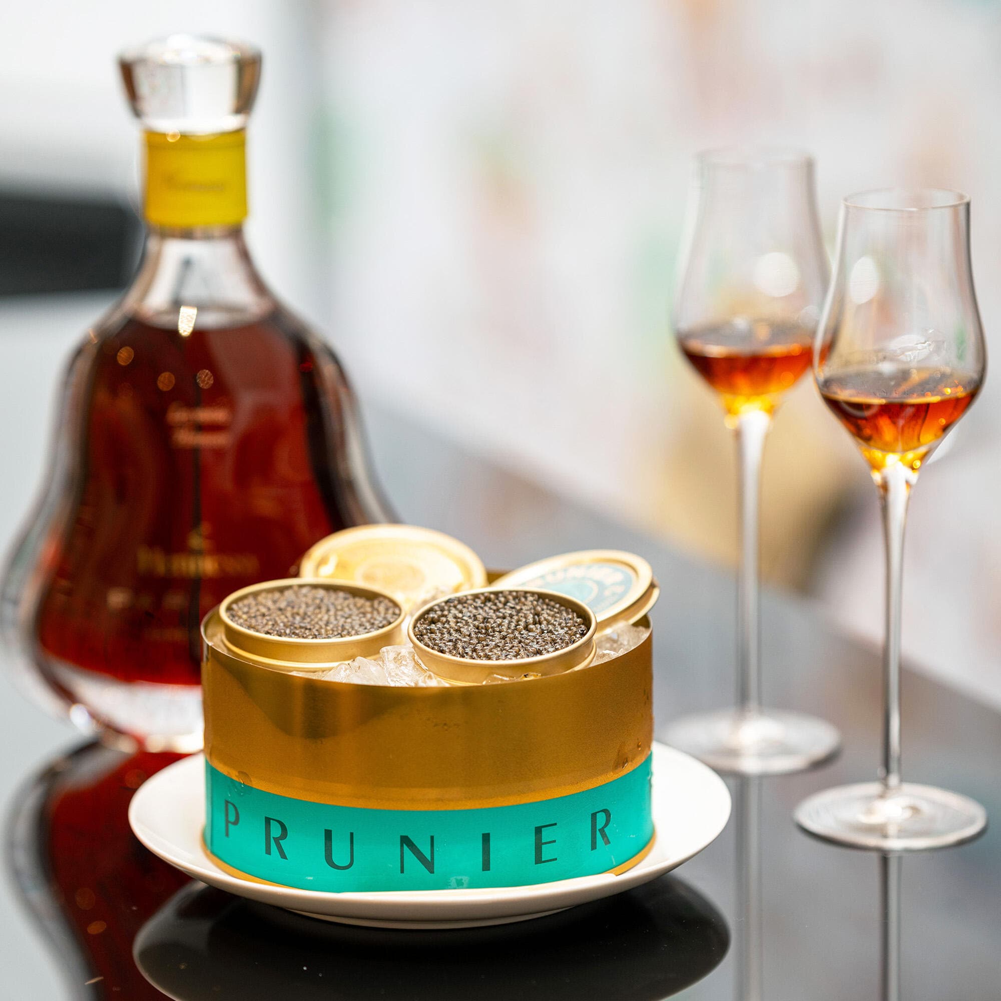 Decanter of Hennessy Paradis cognac with 2 glasses and a tin of Prunier Oscietra Caviar