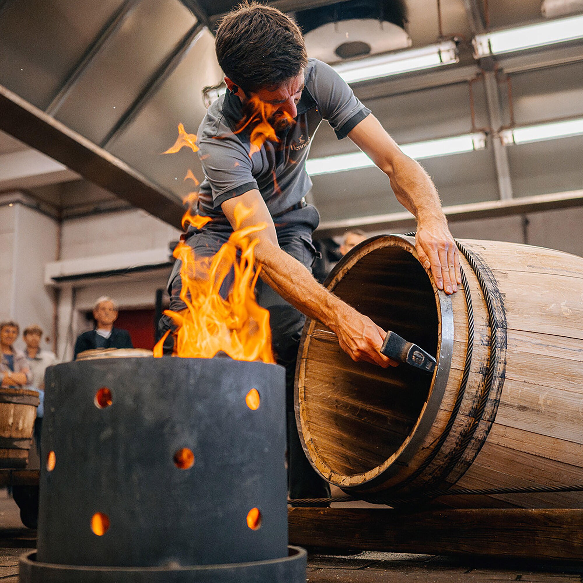 Hennessy cooper using a fire pit to bend a barrel by hand into its final shape