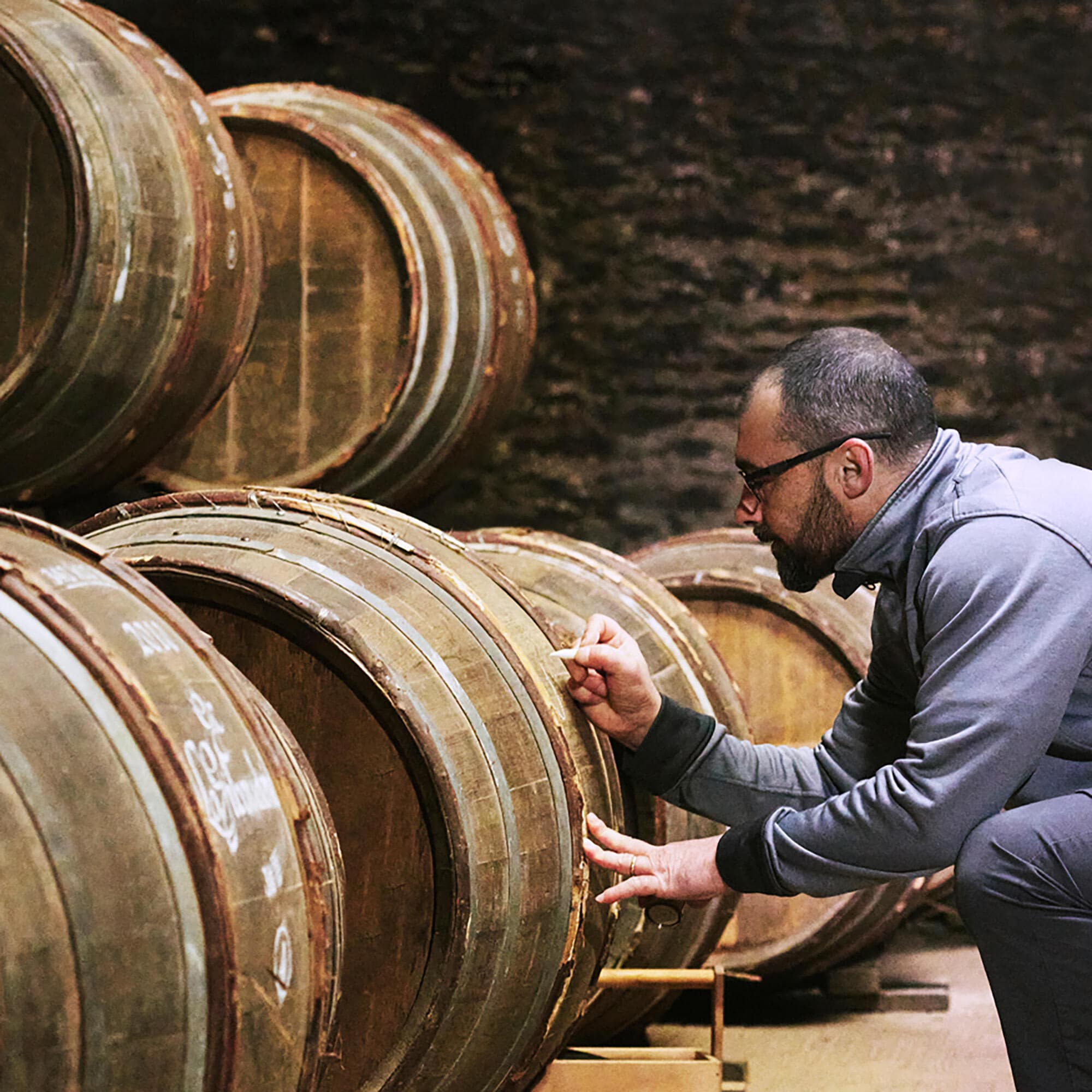 Calligrapher working on a barrel in the Hennessy cellar
